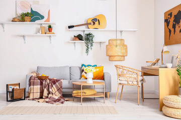 Interior of stylish living room with cozy sofa and comfortable workplace