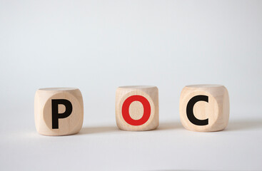 POC - Proof of Concept symbol. Wooden cubes with words POC. Beautiful white background. Business and POC concept. Copy space.