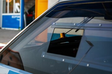 Fototapeta premium Closeup of wheel of car behind window
