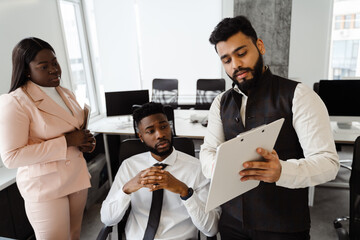 Young multiracial people in business suits working together at office