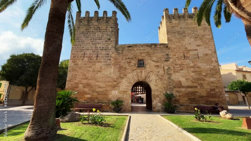 Sticker old city fortifications in mediterranean look with gate and palm trees in front