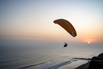 Paragliding during the Sunset in la Costa Verde (Green Coast) in Lima, Peru - 612532026
