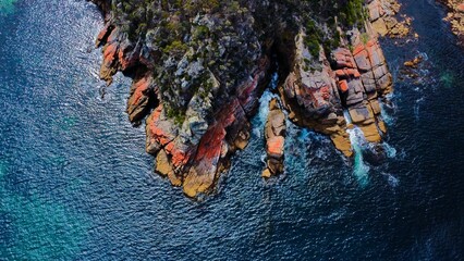 Aerial top view of a rock formation in Haunted Bay, Tasmania, Australia