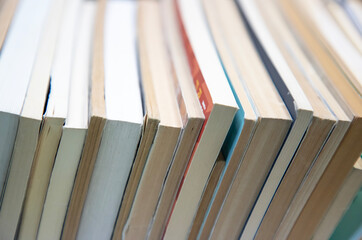 stack of books on self. abstract background with books edge. copy space for text. selective focus...