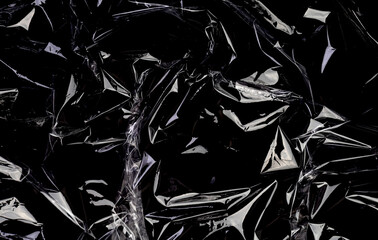 Wrinkled plastic wrap texture on a black background. Transparent cellophane package wallpaper
