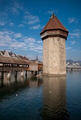 Vertical shot of the Chapel bridge and the tower of Lucerne in Switzerland over the calm Reuss river