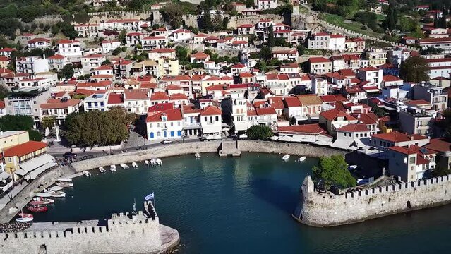 Drone view of the old harbor and coastal buildings of Nafpaktos on a sunny day