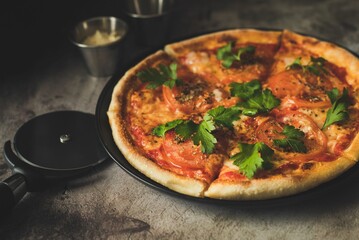 Closeup shot of a pizza on the wooden background