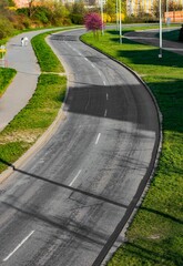 Vertical shot of a road alongside a sidewalk in Prague on a sunny spring day