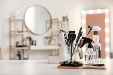 Different hairdressing tools on table in beauty salon - obrazy, fototapety, plakaty