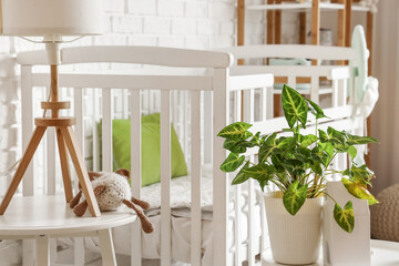 Obraz na płótnie Canvas Baby crib in interior of light bedroom