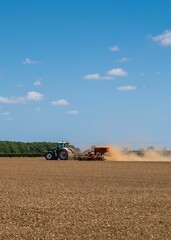 Fototapeta premium Farmer at work ploughing his field
