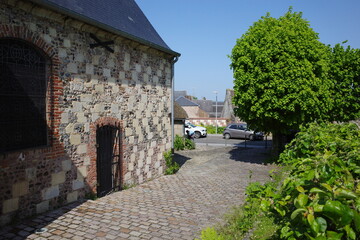Old brick house with black iron bars in Saint-Valery-sur-Somme, France