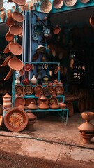 Vertical shot of pots and plates made of clay in a Moroccan open-air market