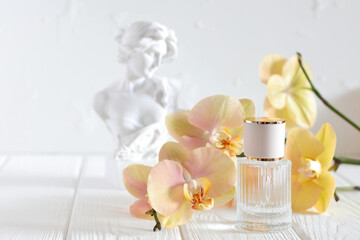 Perfume glass bottle with orchid flowers and head sculpture head