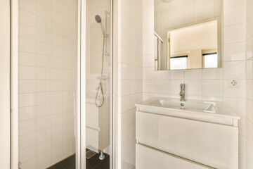 two photographs of a bathroom with a sink and shower