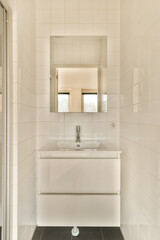 a white bathroom with a sink and a mirror