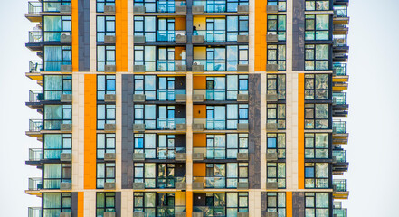 fragment of a modern building with windows and balconies without people
