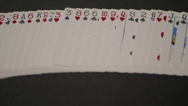 Multi-colored game cards falling on the black background