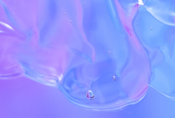 Gel texture of cosmetic products. transparent cream on a blue pink background with bubbles. macro photo. blur and selective focus.