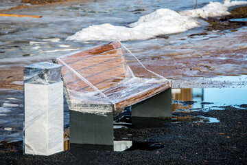 Street benches placed on newly laid tiles and packed in polyethylene