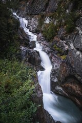 Naklejka premium Vertical long exposure shot of the Umbal Falls, Tyrol, Austria