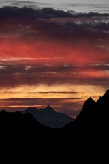Silhouette mountains under colorful sky during sunset