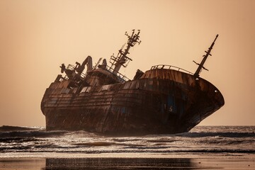 Beautiful shot of a historic dirty old ship after a shipwreck on a seashore