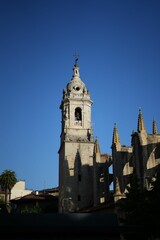 Obraz premium Vertical shot of a cathedral under a clear blue sky in Lekeitio, Spain