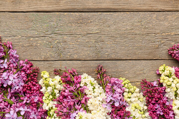 Fototapeta na wymiar Lilac twigs on wooden background