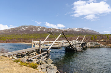 Wooden bridge over an icy cold Norwegian river. Western-like feeling in this scenery.