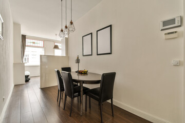 a dining room with a table and chairs and a