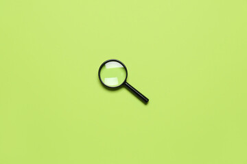 Black mini magnifier on green background