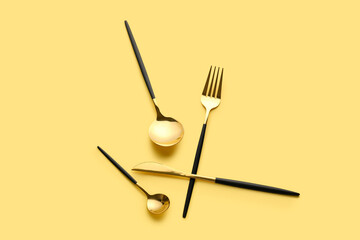 Stylish cutlery on yellow background