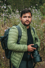 man with backpack, jacket and camera