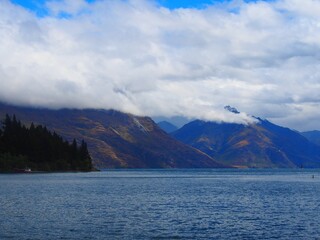 Beautiful landscape of a lake with cloudy hills in the background