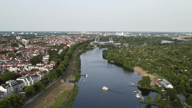 Drone view of the Weser river surrounded by buildings in Bremen, Germany in 4K