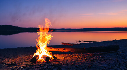 beautiful campfire in the middle of the beach at sunset