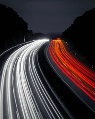 Gordijnen Vertical shot of a highway at night with long exposure lights © Nomixvisuals/Wirestock Creators