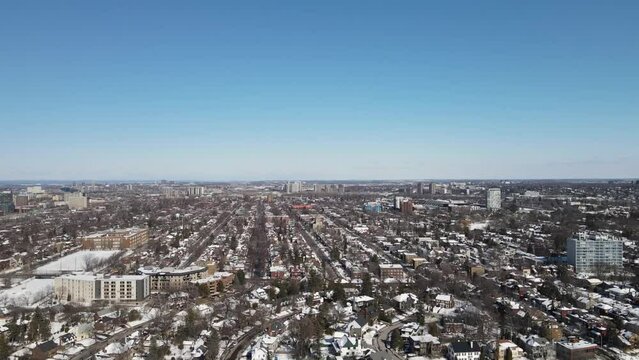 Aerial of the frozen Dow's Lake with the Ottawa snowy cityscape on a sunny winter day