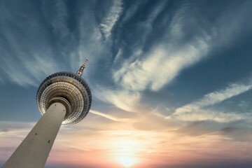 Low angle view of Berliner Fernsehturm tower during sunset