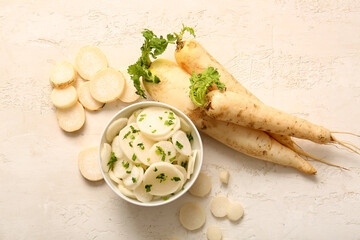 Bowl with slices of fresh daikon radish on white background