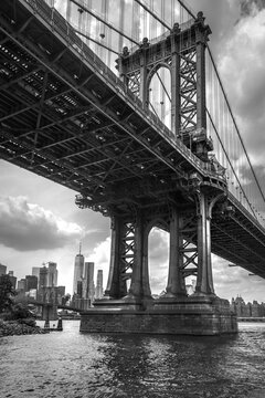 Brooklyn Bridge over The East River in New York, with a cityscape in the background, in a grayscale © Felix Garcia Vila/Wirestock Creators