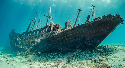 amazing rusty ship sunk in the middle of the sea with good day lighting in the blue pacific sea