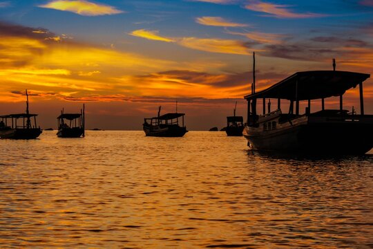 Beautiful sunset over the sea with boats near Belitung Island, Indonesia.