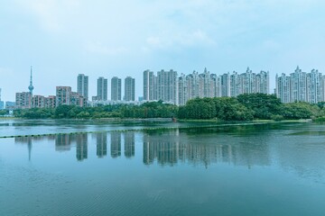 Fototapeta na wymiar Low-angle of high-rise buildings in Fuzhou with a lake view, Fujian province, China