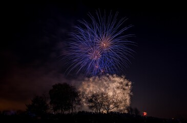 Beautiful shot of exploding colorful fireworks in a night sky over Heaton Park