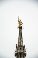 Fototapeta na wymiar Vertical shot of a rooftop tower of Duomo di Milano