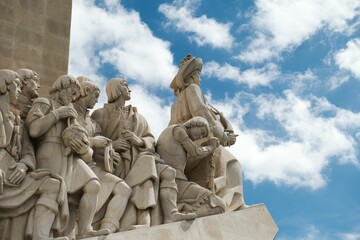Closeup of the stone sculpture Padrao dos Descobrimentos against a cloudy sky