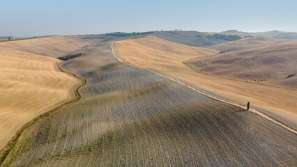 Aerial view of the Tuscany fields located in Italy seen on a beautiful sunny day